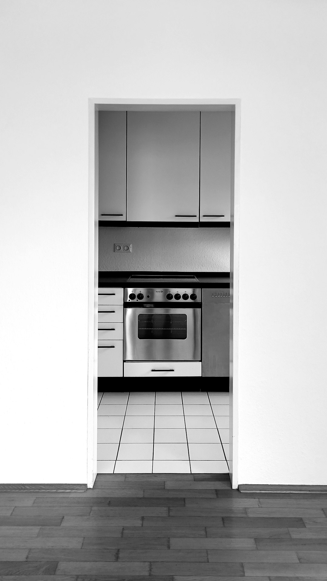 an-empty-kitchen-with-a-stove-and-oven-esah8dfrjvi