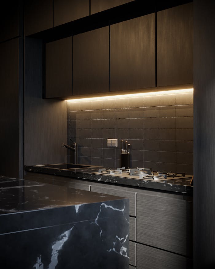 A sleek and modern kitchen design featuring dark cabinetry and ambient lighting.